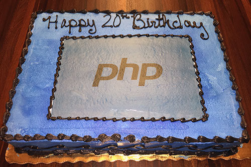 A cake with the PHP logo and text that reads “Happy 20th Birthday”