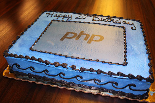 A cake with the PHP logo and text that reads “Happy 20th Birthday”