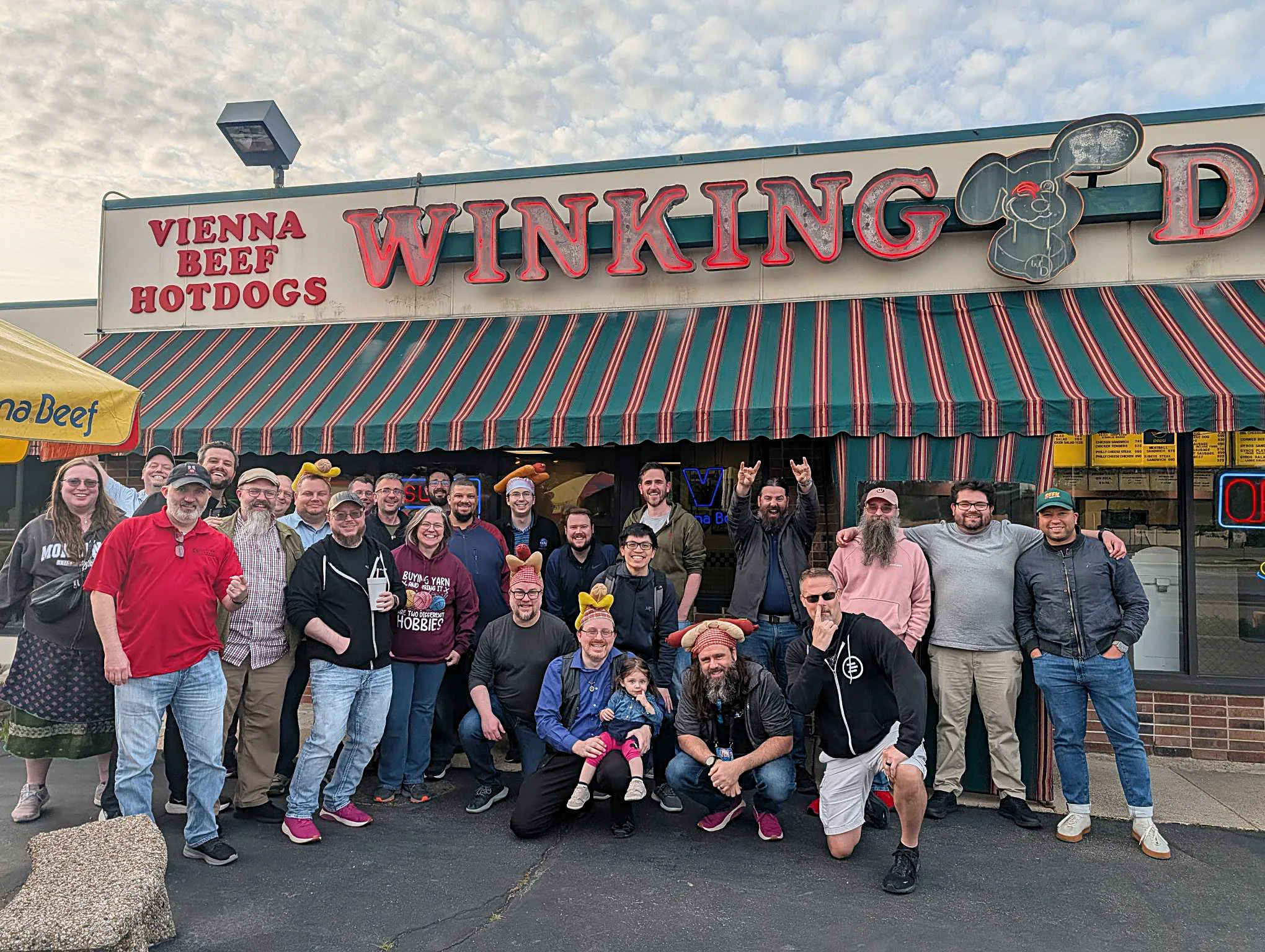 A crowd of PHP developers pose for a group photo outside the Winking Dog